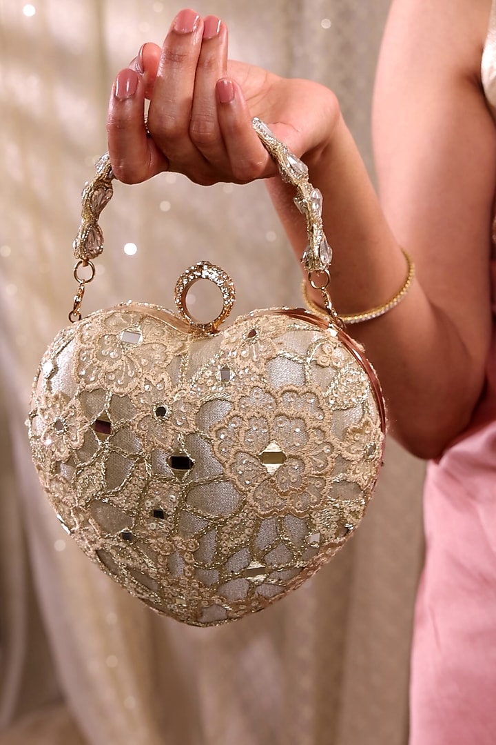 Gold Tissue Mirror Embroidered Heart Potli Bag by AMYRA at Pernia's Pop Up Shop