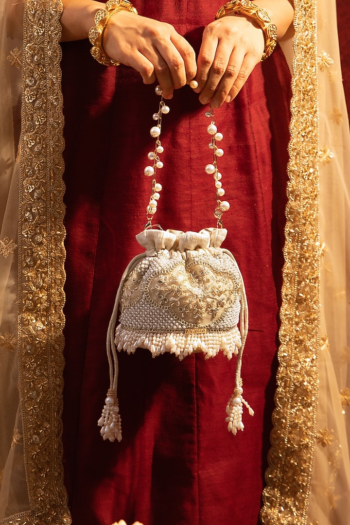 Beige Poly Silk Pearl Hand Embroidered Mini Potli by AMYRA at Pernia's Pop Up Shop