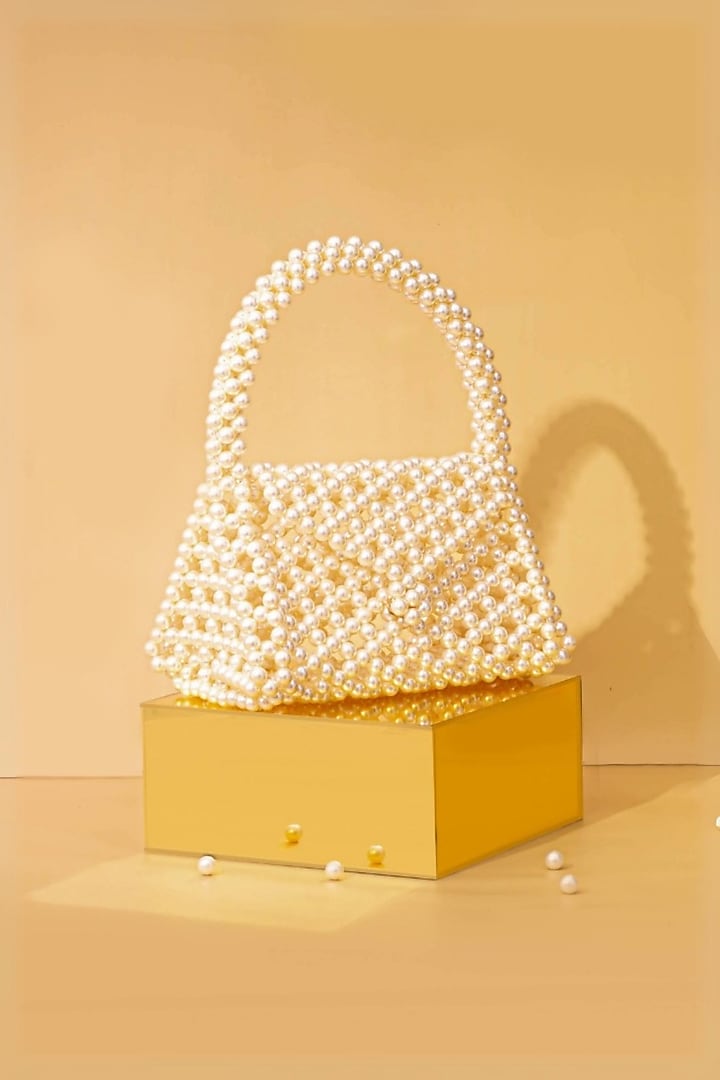 Off-White Pearl Triangle Handbag by AMYRA at Pernia's Pop Up Shop