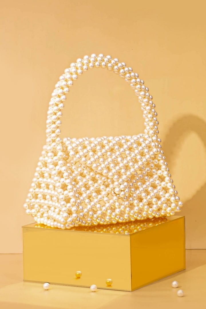 Off-White Pearl Triangle Handbag by AMYRA at Pernia's Pop Up Shop