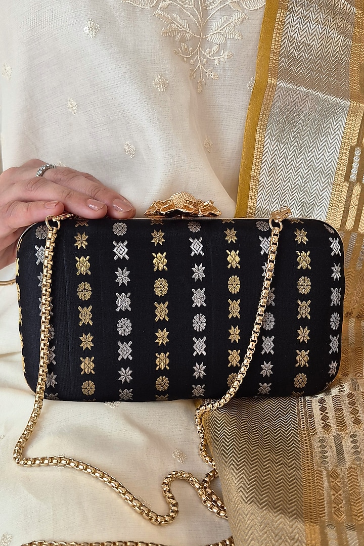 Black Pure Kanchi Silk Zari Boota Work Clutch by AMYRA at Pernia's Pop Up Shop