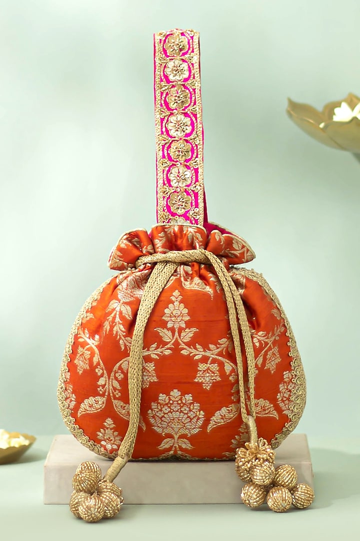 Rust Orange Handwoven Raw Silk Sequins Embellished Potli by AMYRA at Pernia's Pop Up Shop