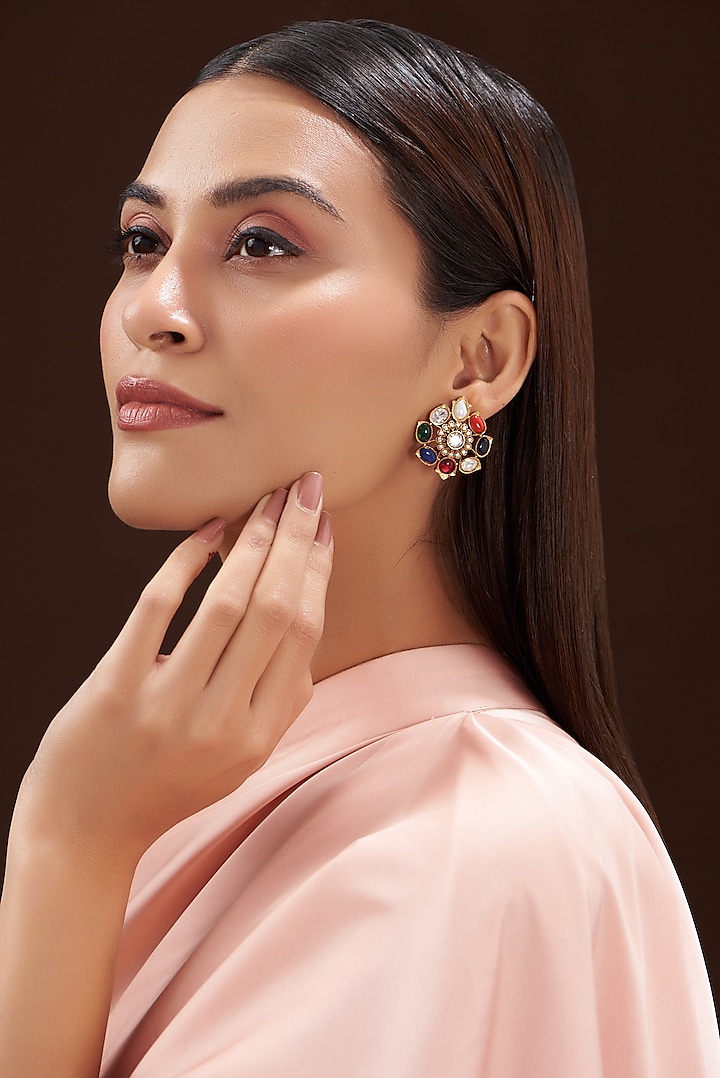 Gold Finish Navratna Stone Stud Earrings by Anjali Jain Jewellery
