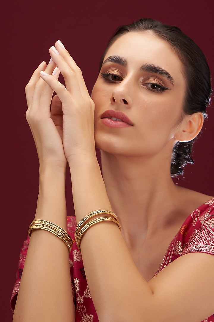 Gold Plated Carved Temple Bangles (Set Of 4) by Anjali Jain Jewellery at Pernia's Pop Up Shop