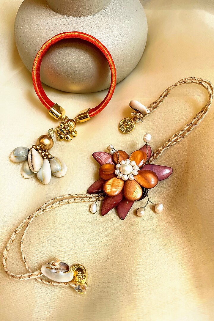 Red & Orange Floral Rakhi & Lumba (Set of 2) by Anjali Jain Jewellery at Pernia's Pop Up Shop
