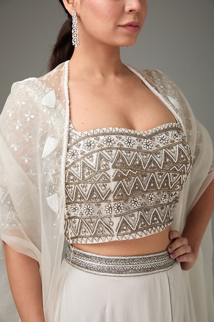 Ivory Flat Chiffon Embellished Layered Cape Wedding Lehenga Set by ANJALIVERMA at Pernia's Pop Up Shop