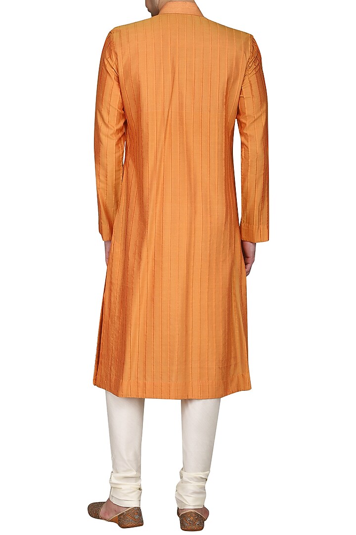 Orange pintucks kurta with ivory churidar pants available only at Pernia's Pop Up Shop.