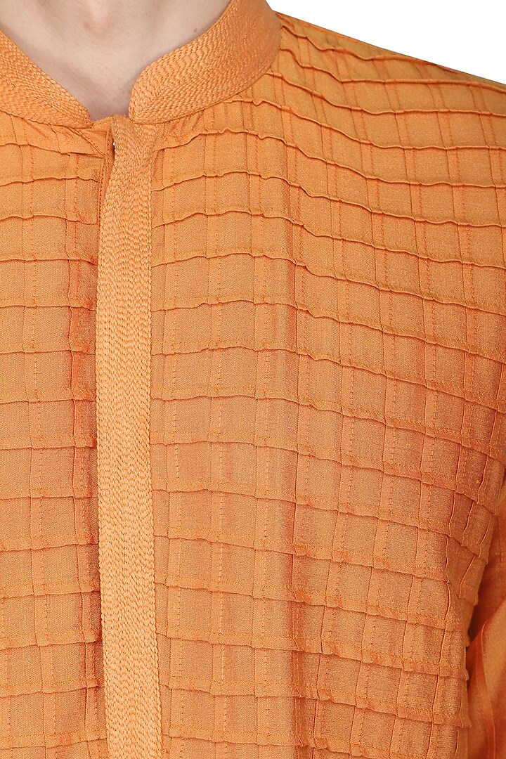 Orange pintucks kurta with ivory churidar pants available only at Pernia's Pop Up Shop.