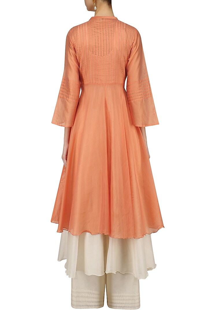 Pale orange pintuck kurta and off white palazzo pants set available only at Pernia's Pop Up Shop.