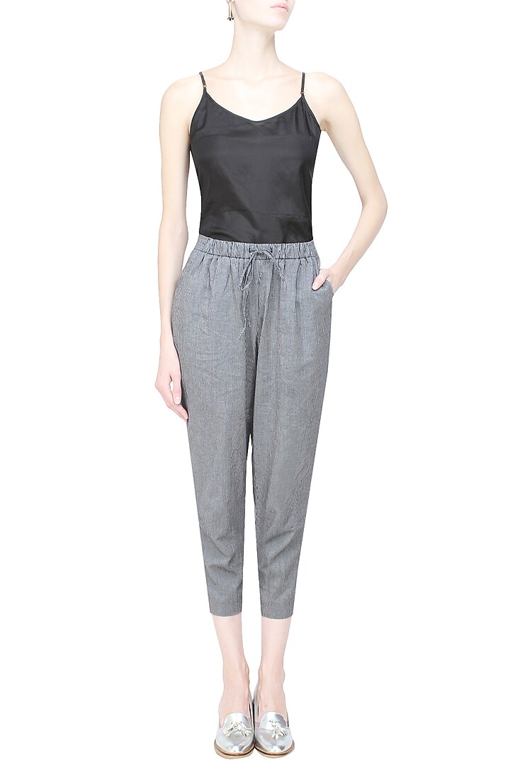 Anomaly presents Black pinstriped relaxed drawstring pants available only at Pernia's Pop Up Shop.