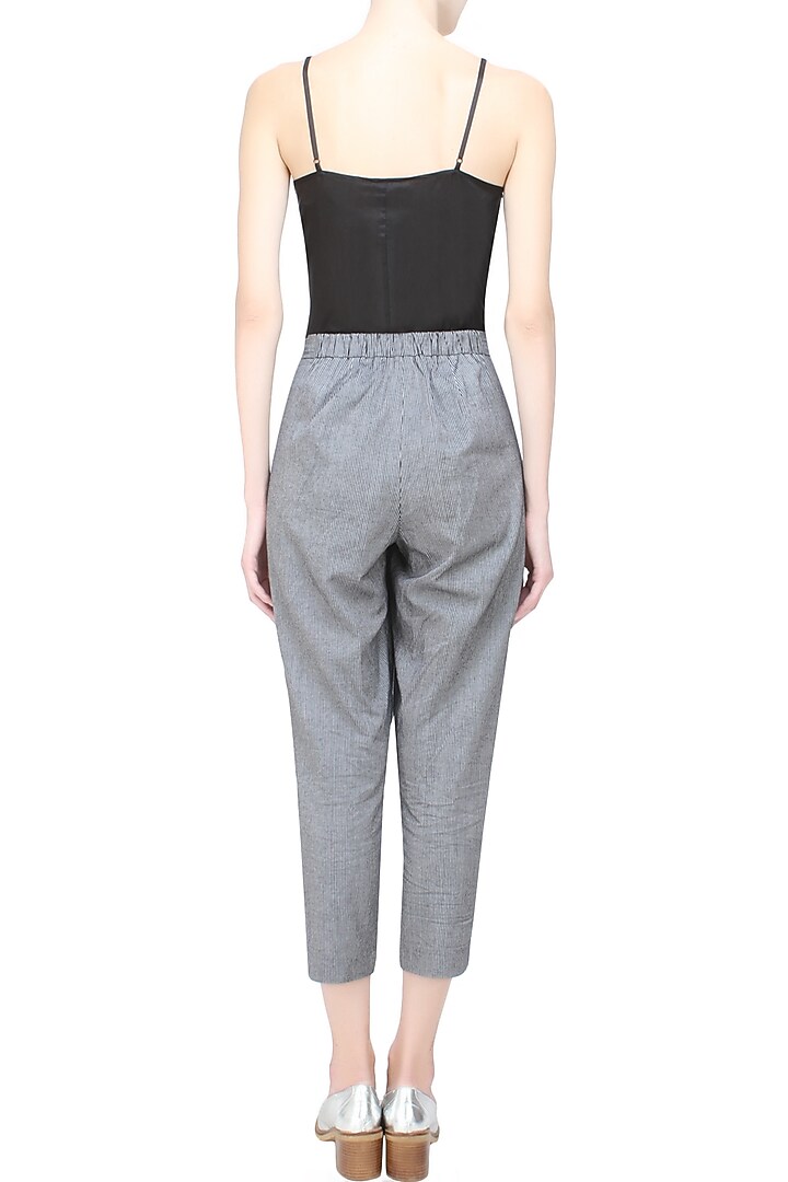 Anomaly presents Black pinstriped relaxed drawstring pants available only at Pernia's Pop Up Shop.