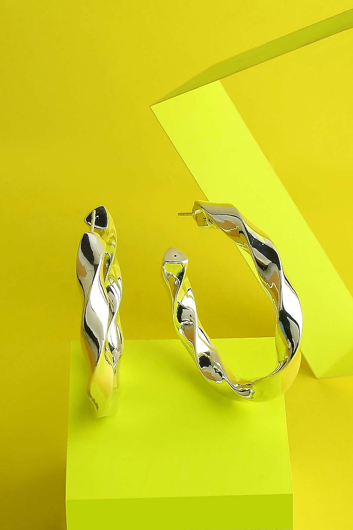 White Finish Swivel Hoop Earrings In Sterling Silver by ARVINO at Pernia's Pop Up Shop