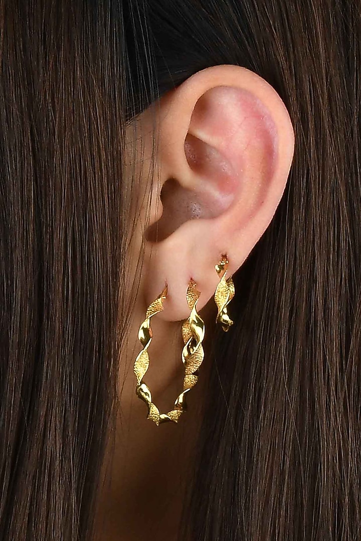 Gold Finish Twisted Hoop Earrings In Sterling Silver by ARVINO at Pernia's Pop Up Shop