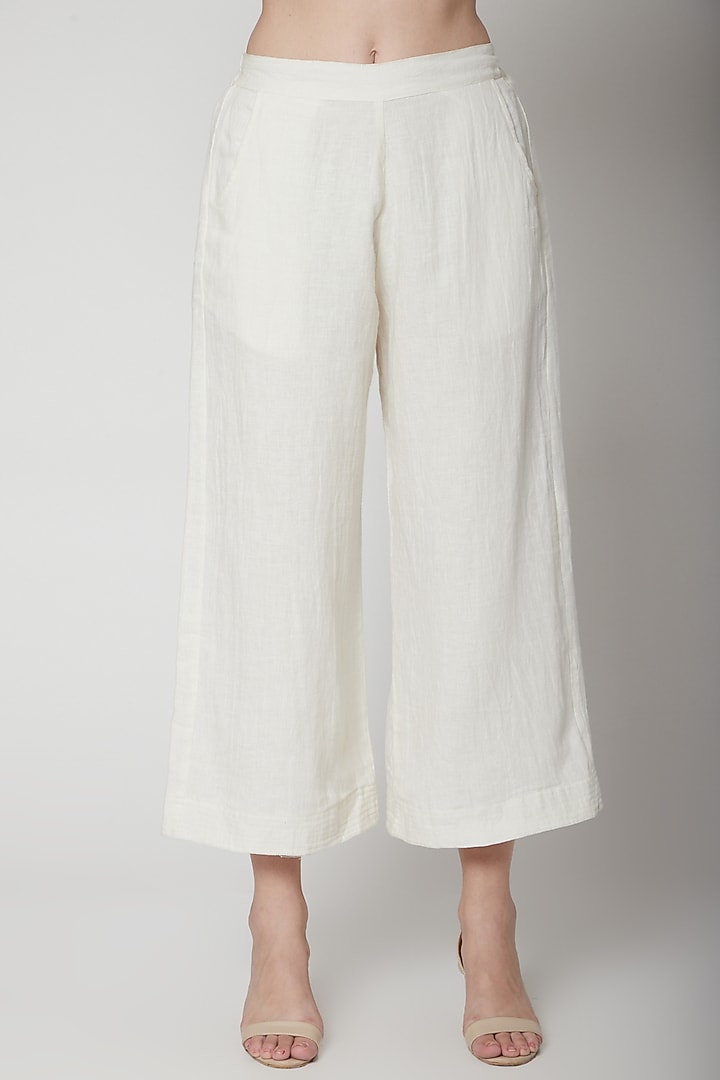 White Flared Pants With Pockets by AURUHFY at Pernia's Pop Up Shop