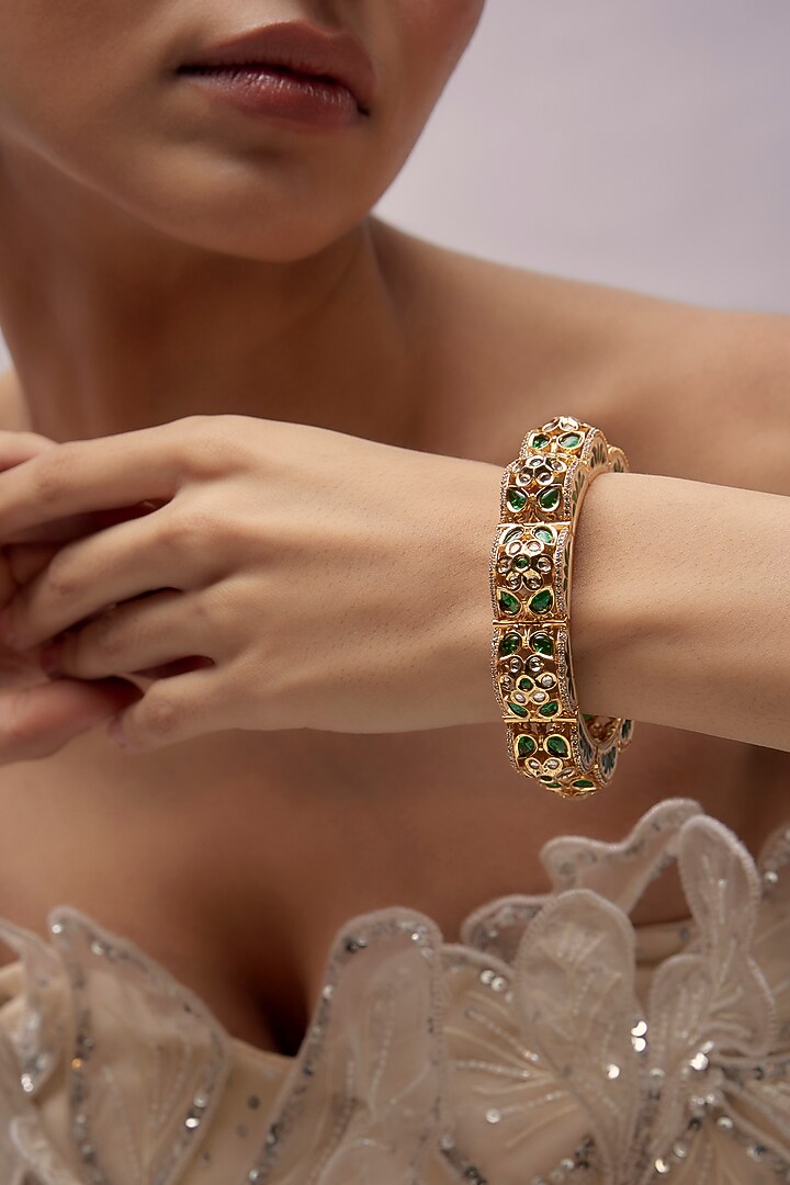 Gold Finish Uncut Stone & Emerald Synthetic Stone Bracelet by Aryah Jewels at Pernia's Pop Up Shop