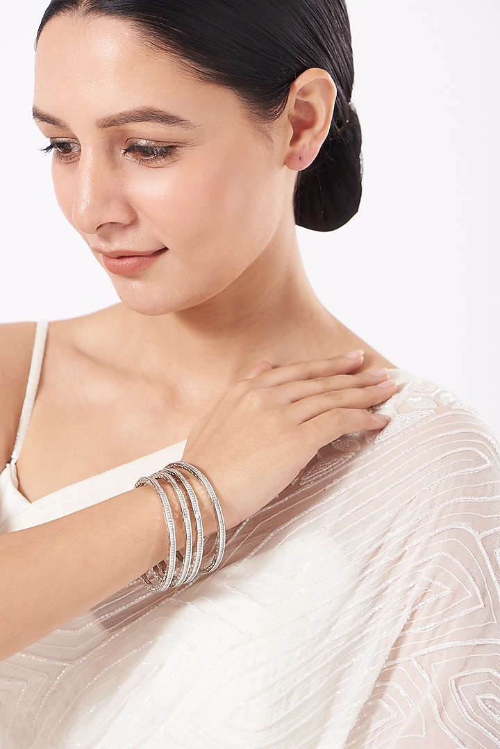 White Finish Mixed Metal Faux Diamonds Bangles (Set of 4) by Aster at Pernia's Pop Up Shop