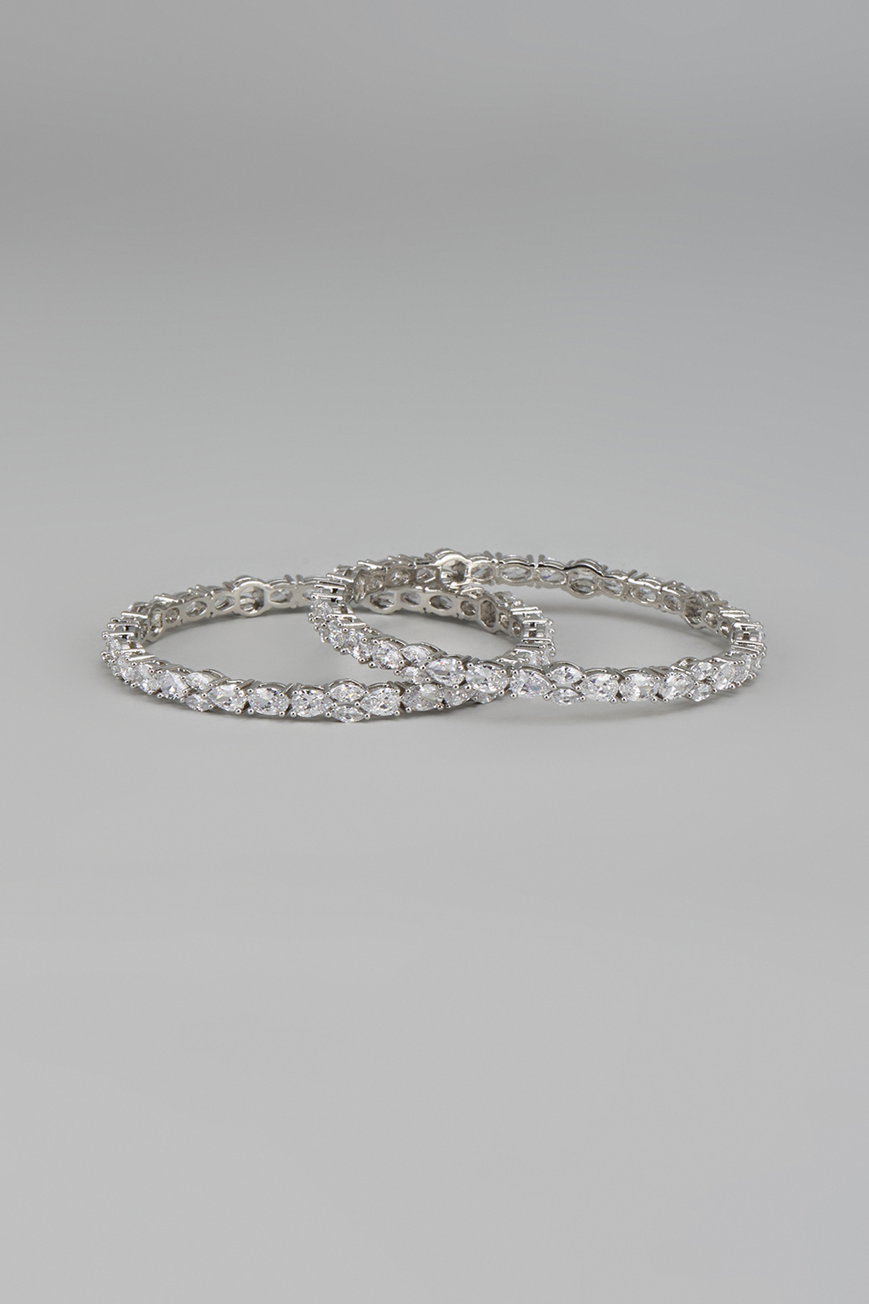 White Finish Zircon Bangles (Set Of 2) by Aster at Pernia's Pop Up Shop