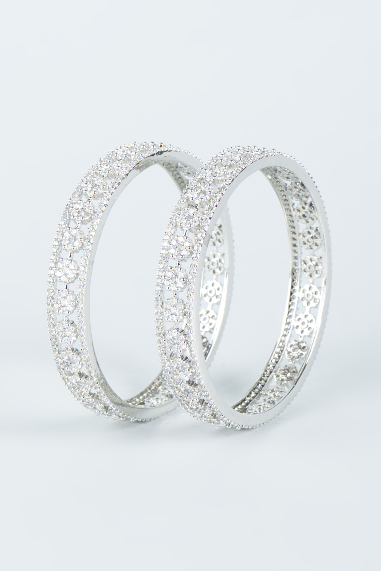 White Finish Zircon Bangles (Set of 2) by Aster at Pernia's Pop Up Shop