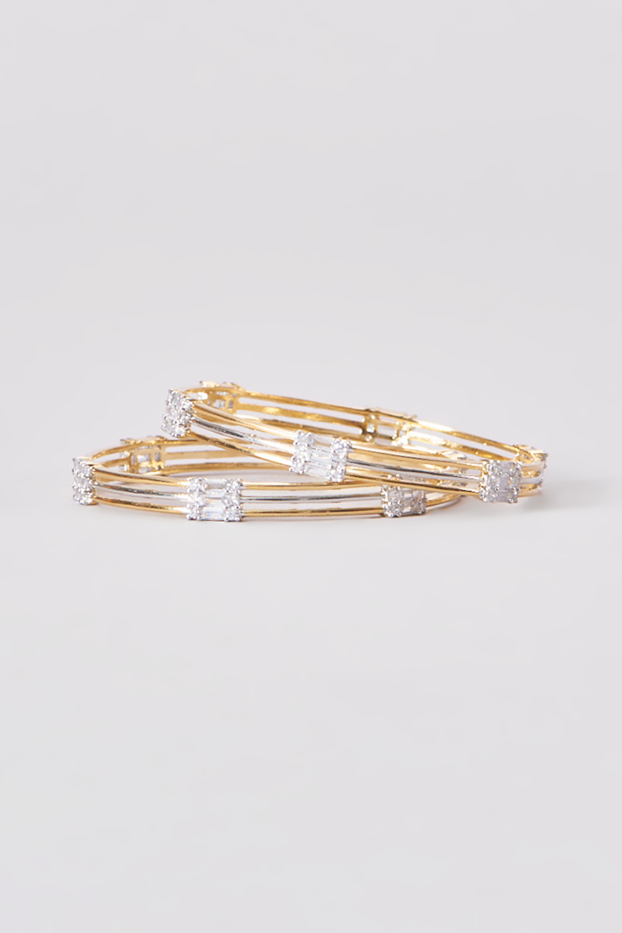 Gold Finish Zircon Bangles (Set of 2) by Aster at Pernia's Pop Up Shop