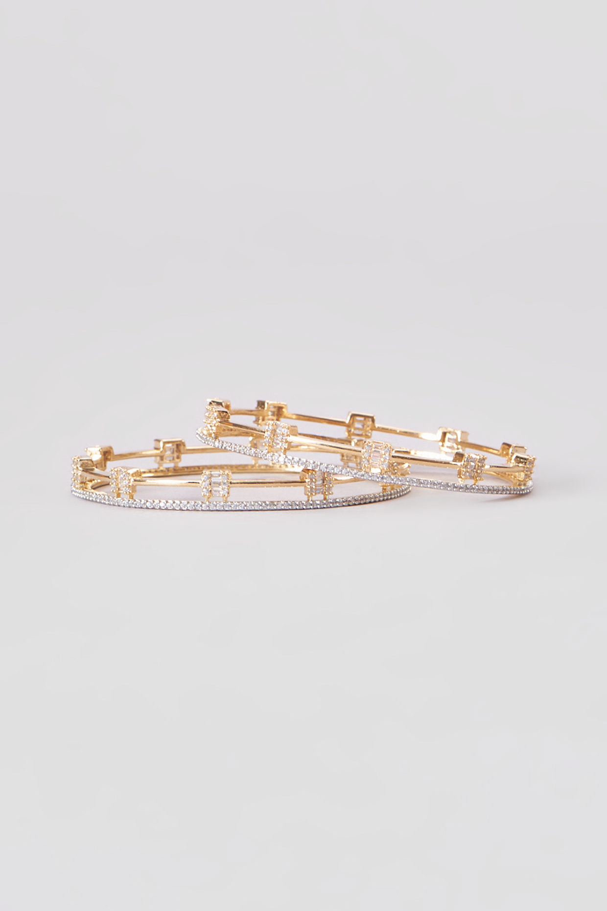 Gold Finish Zircon Bangles (Set of 2) by Aster at Pernia's Pop Up Shop