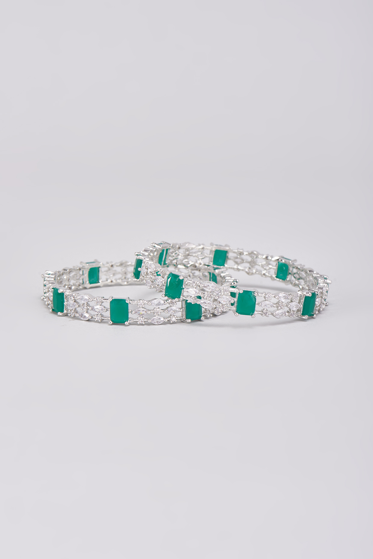 White Finish Zircons & Green Stone Bangles (Set Of 2) by Aster at Pernia's Pop Up Shop