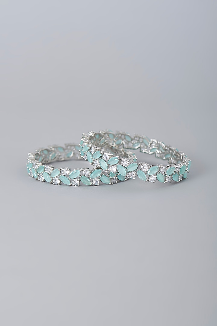White Finish Faux Diamonds & Aqua Synthetic Stones Bangles (Set Of 2) by Aster at Pernia's Pop Up Shop