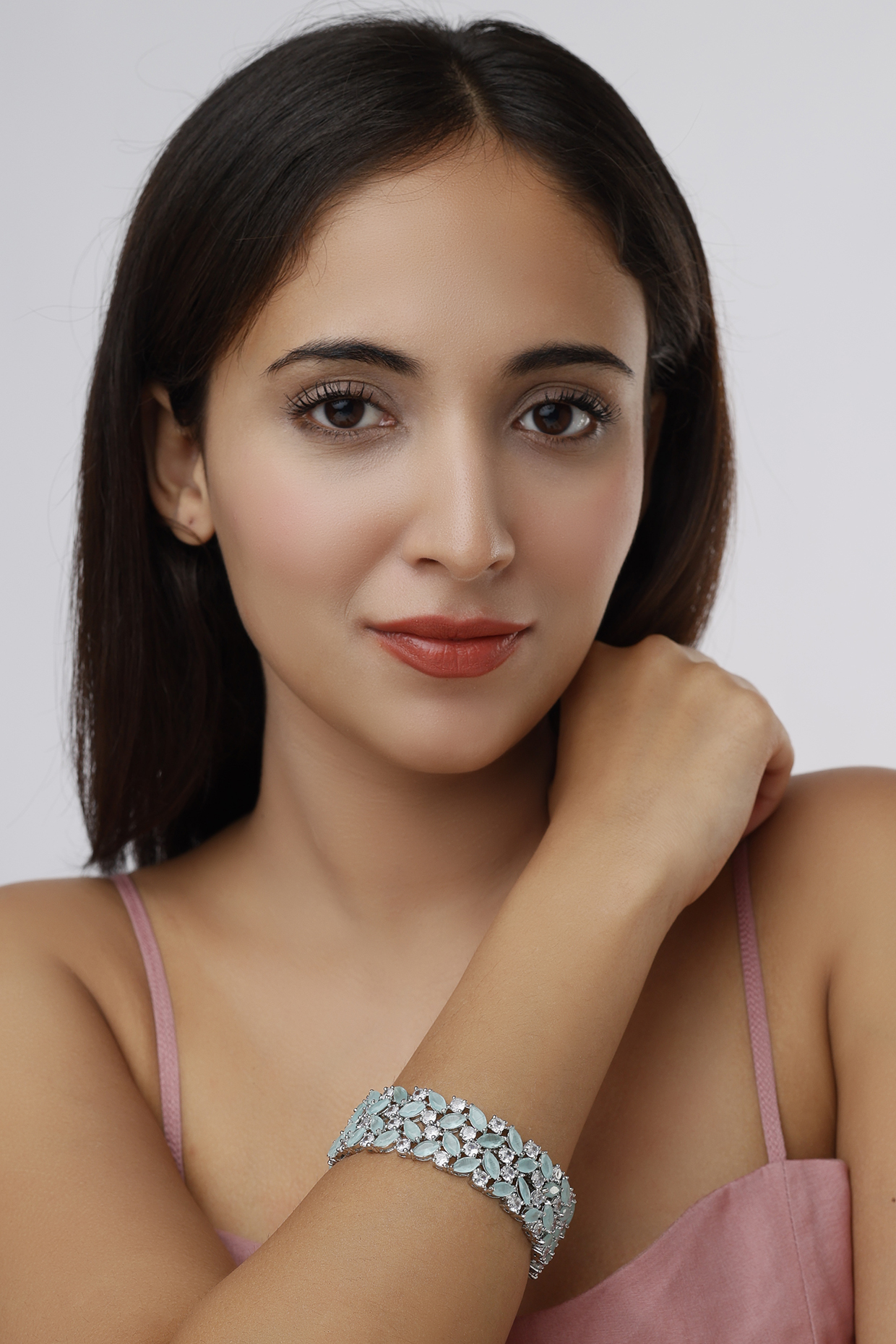 White Finish Faux Diamonds & Aqua Synthetic Stones Bangles (Set Of 2) by Aster at Pernia's Pop Up Shop