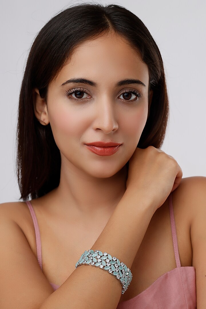 White Finish Faux Diamonds & Aqua Synthetic Stones Bangles (Set Of 2) by Aster at Pernia's Pop Up Shop