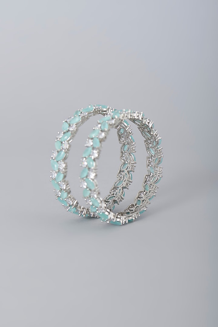 White Finish Faux Diamonds & Aqua Synthetic Stones Bangles (Set Of 2) by Aster at Pernia's Pop Up Shop