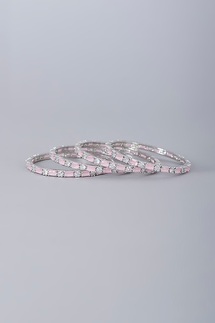 White Finish Faux Diamonds & Pink Synthetic Stones Bangles (Set Of 4) by Aster at Pernia's Pop Up Shop