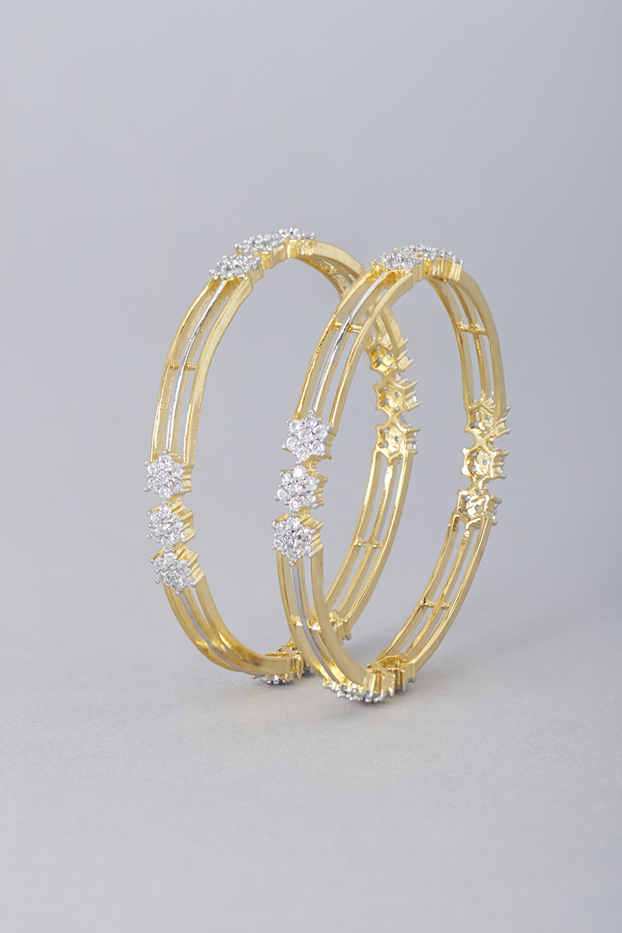 Gold Finish Zircon Bangles (Set of 2) by Aster at Pernia's Pop Up Shop