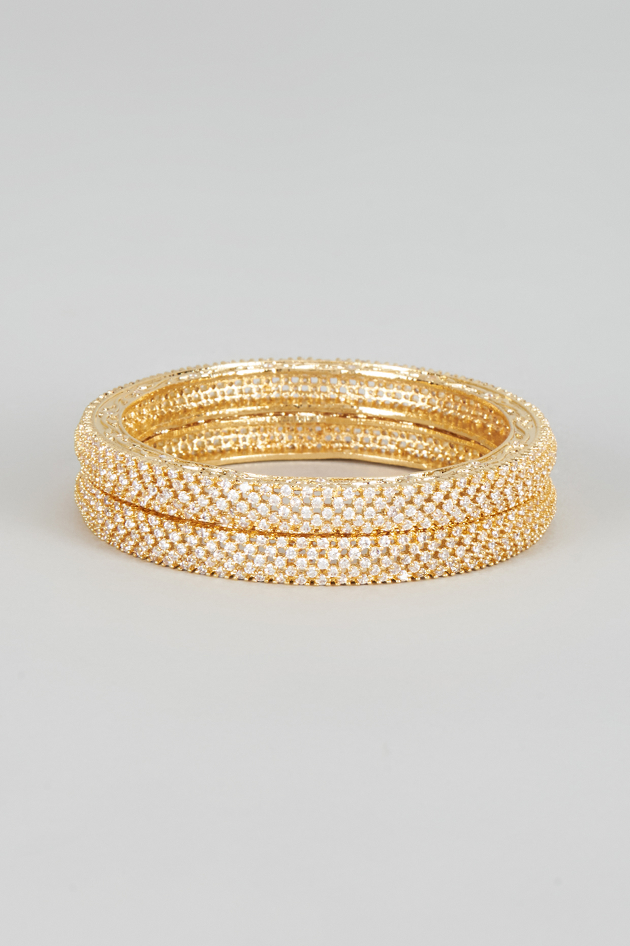 Gold Finish Zircon Bangles (Set of 2) by Aster at Pernia's Pop Up Shop