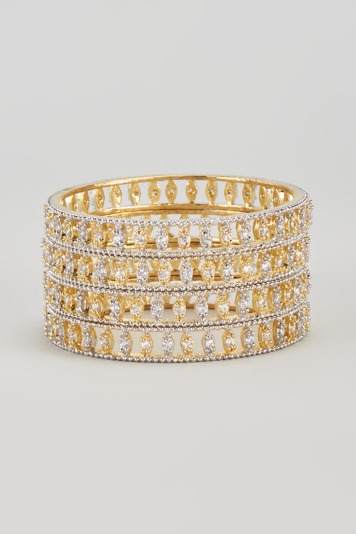 Gold Finish Zircon Bangles (Set of 4) by Aster at Pernia's Pop Up Shop
