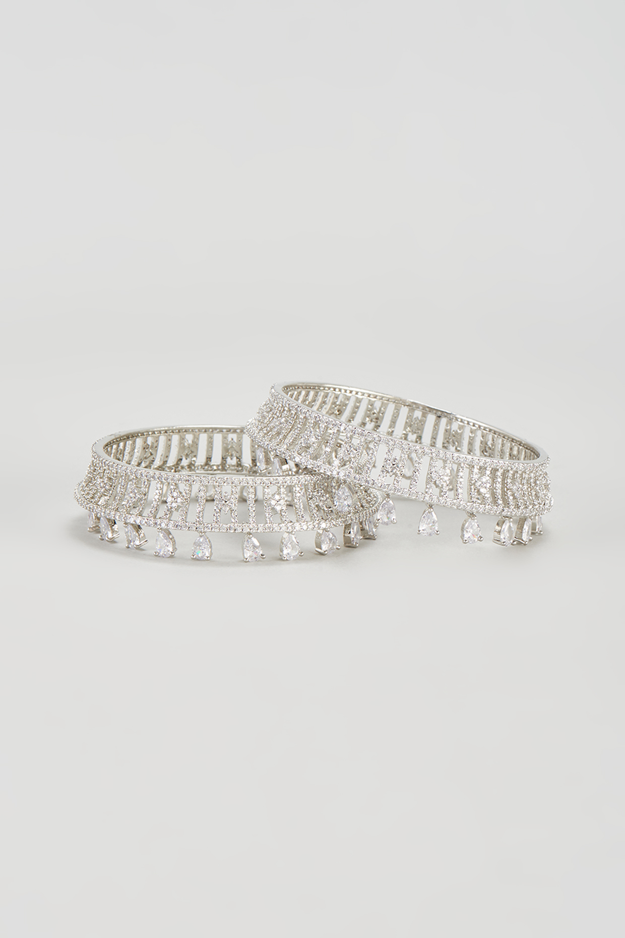 White Finish Zircon Bangles (Set of 2) by Aster at Pernia's Pop Up Shop