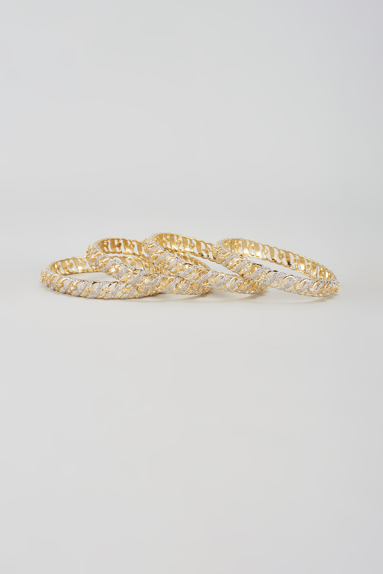 Gold Finish Zircon Bangles (Set of 4) by Aster at Pernia's Pop Up Shop