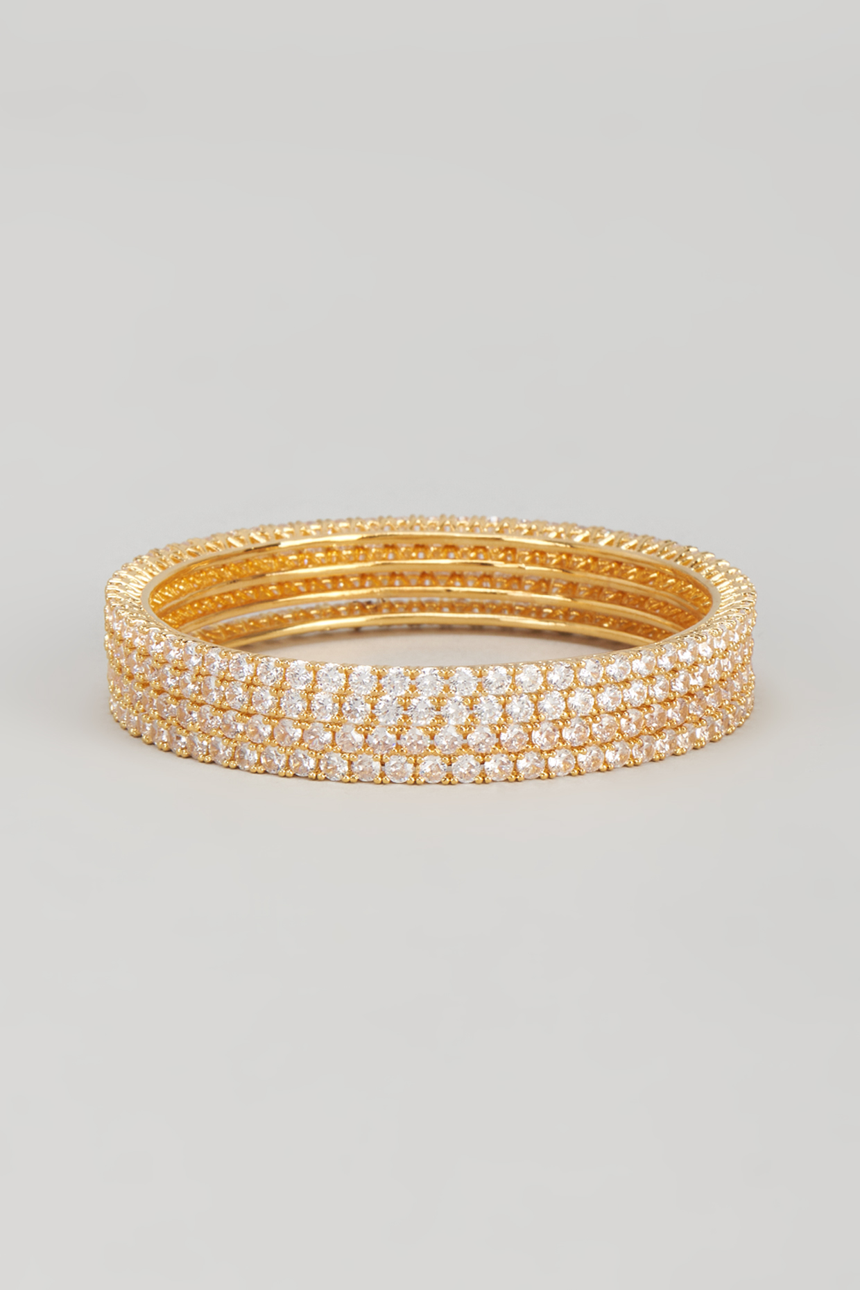 Gold Finish Zircon Bangles (Set of 4) by Aster at Pernia's Pop Up Shop