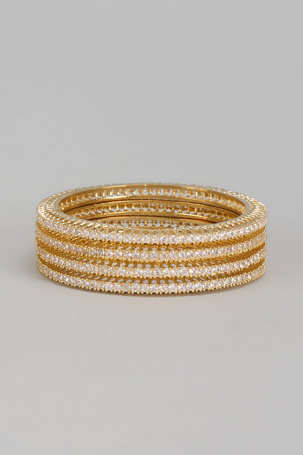 Gold Finish Zircon Bangles (Set of 4) by Aster at Pernia's Pop Up Shop