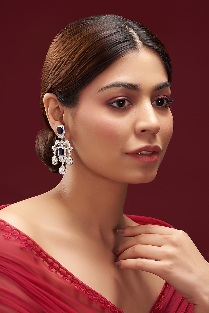 White Finish Faux Diamond & Blue Sapphire Dangler Earrings by Aster at Pernia's Pop Up Shop