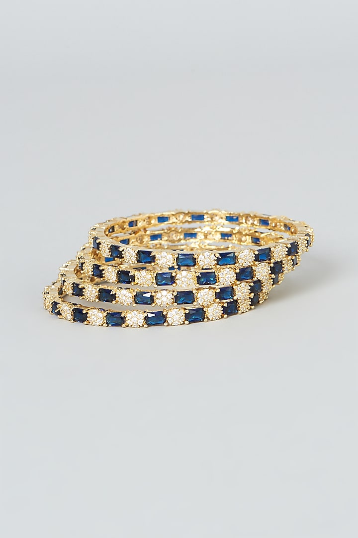 Gold Finish Blue Zircons Bangles (Set of 4) by Aster at Pernia's Pop Up Shop