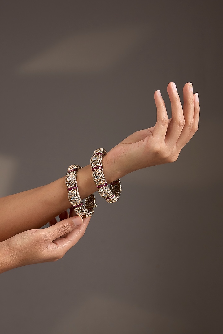 Antique Gold Finish Kundan Polki & Ruby Pink Stone Bangles (Set Of 2) by Aura Trends at Pernia's Pop Up Shop