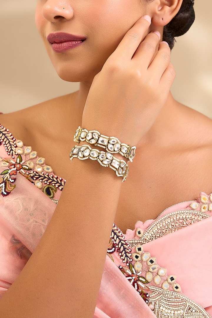 Gold Finish Kundan Polki Floral Bangles (Set Of 2) by Aura Trends at Pernia's Pop Up Shop