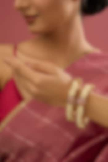 Rose Gold Finish Kundan Polki & Pearl Bangles (Set Of 2) by Auraa Trends at Pernia's Pop Up Shop