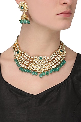 Gold finish kundan and green stone bridal necklace set  by Aura Trends