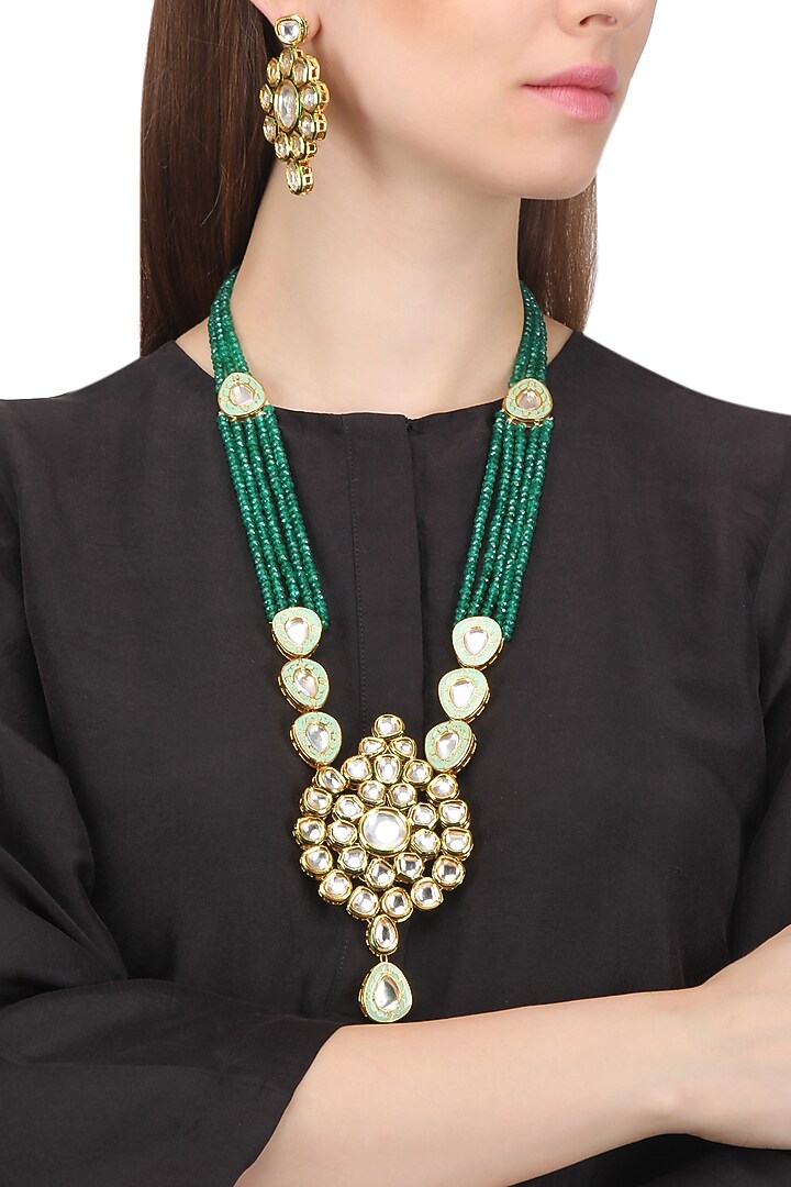 Gold finish kundan and green semi precious stone necklace set available only at Pernia's Pop Up Shop.