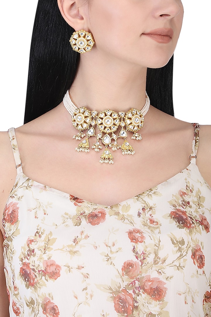 Gold plated white kundan and pearl bunch choker necklace set by AURAA TRENDS