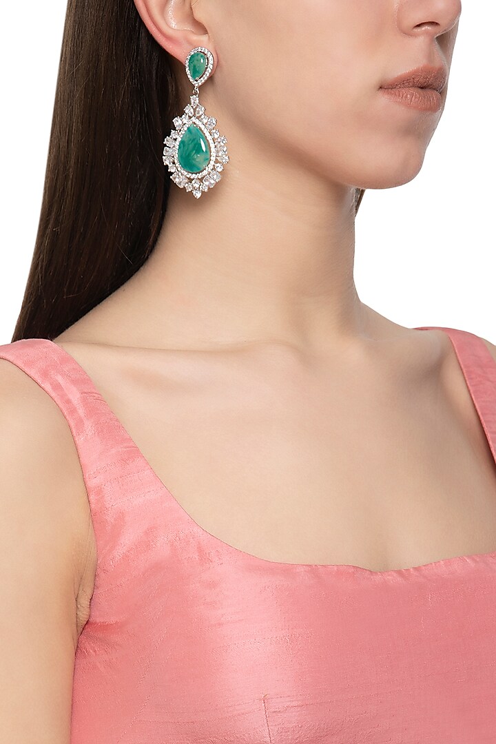 White finish diamond and green stone earrings by Auraa Trends