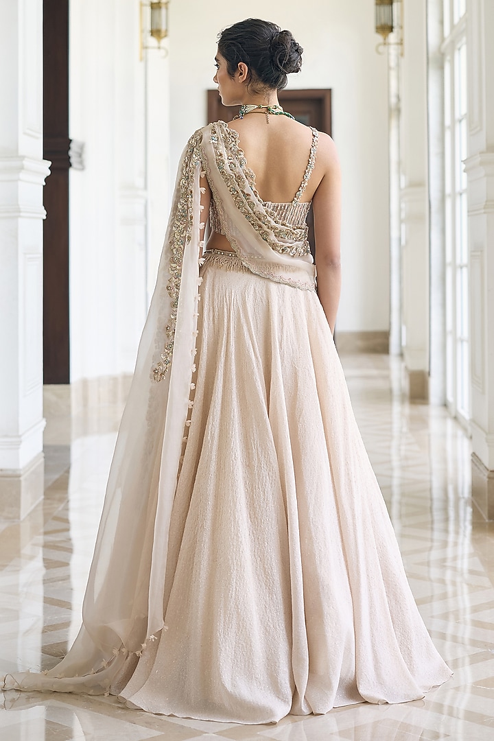 Ivory Modal Satin Embellished Draped Wedding Lehenga Set by AWIGNA BY VARSHA & RITTU at Pernia's Pop Up Shop