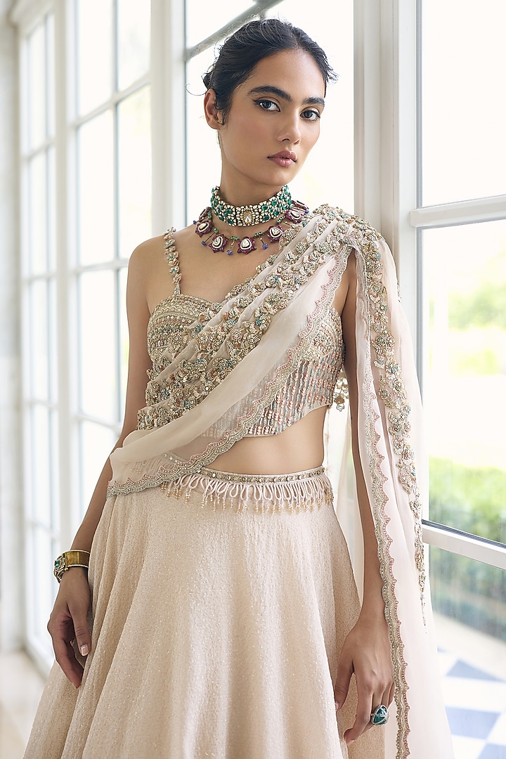 Ivory Modal Satin Embellished Draped Wedding Lehenga Set by AWIGNA BY VARSHA & RITTU at Pernia's Pop Up Shop