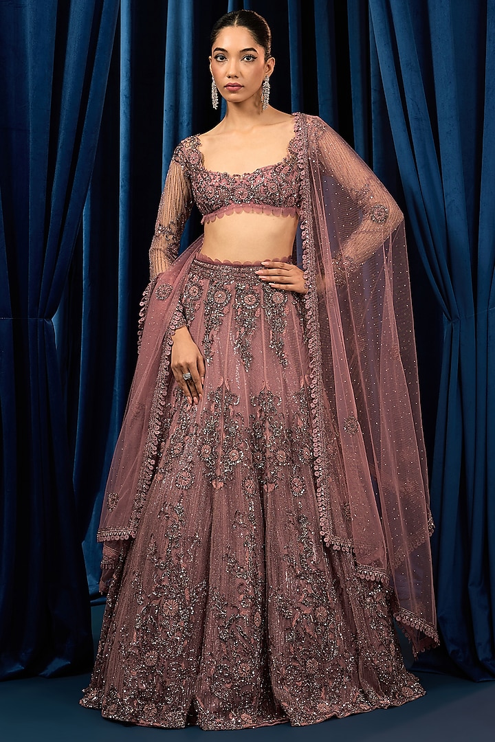 Dusty Onion Pink Net Floral Motifs Embroidered Wedding Lehenga Set by AWIGNA BY VARSHA & RITTU at Pernia's Pop Up Shop