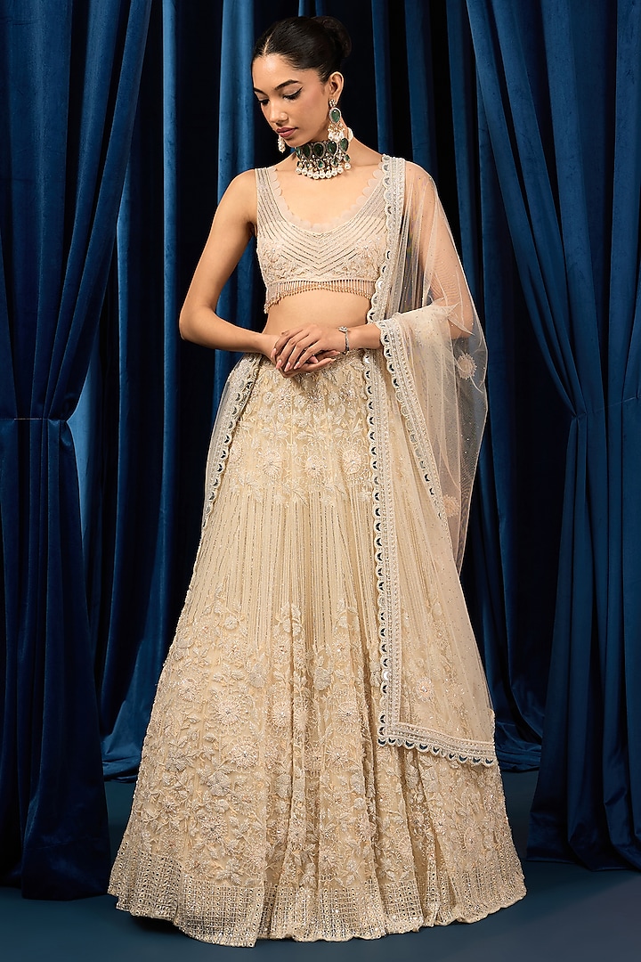 Ivory Net Floral Embroidered Bridal Lehenga Set by AWIGNA BY VARSHA & RITTU at Pernia's Pop Up Shop